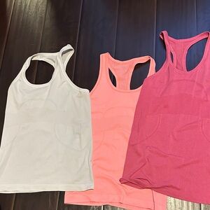 SOLD. Bundle of 3 lululemon tanks swiftly size 6 
Hip length